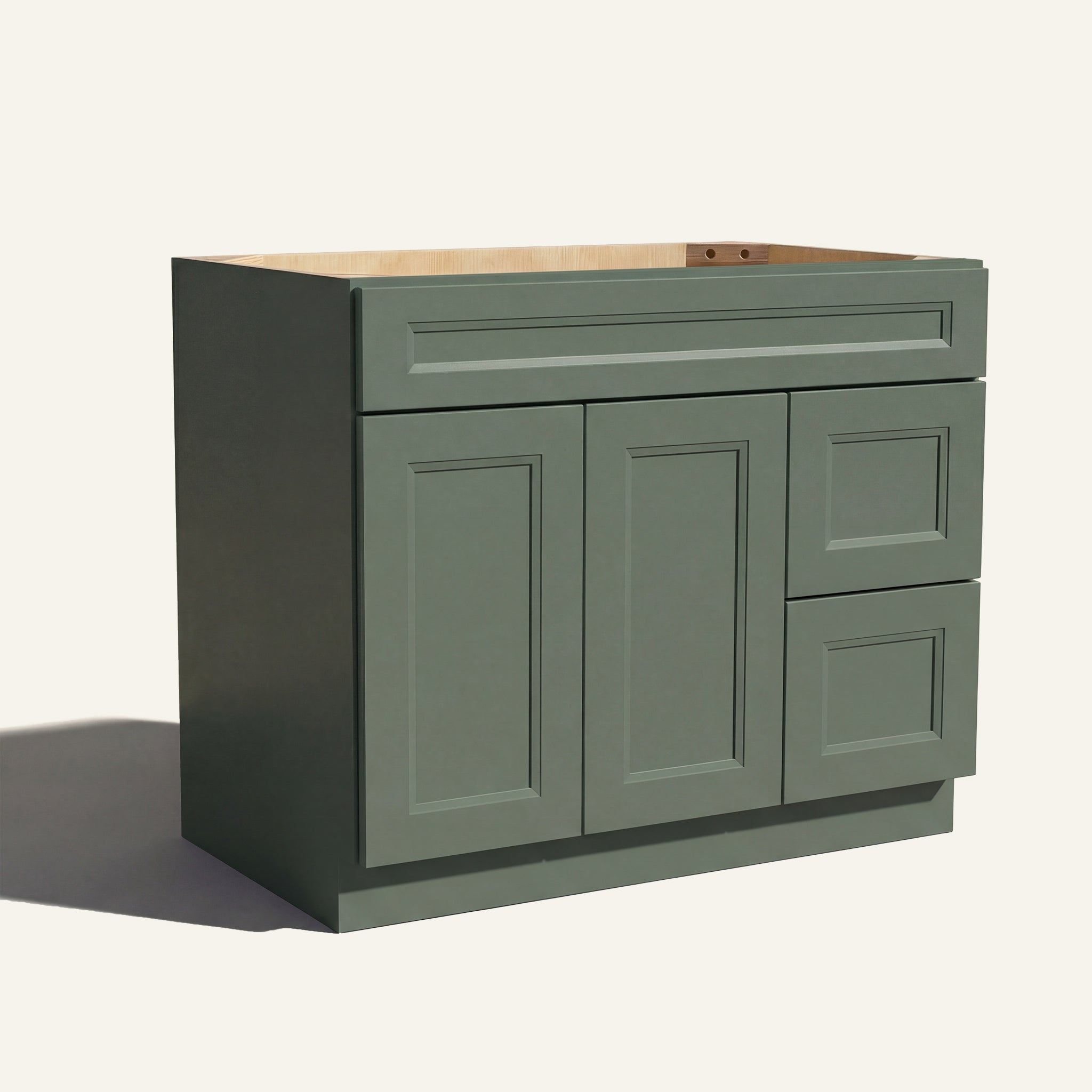 Angled view of green Belmont beveled Shaker single sink vanity, 2 doors, 2 drawers right, and 1 false drawer front.