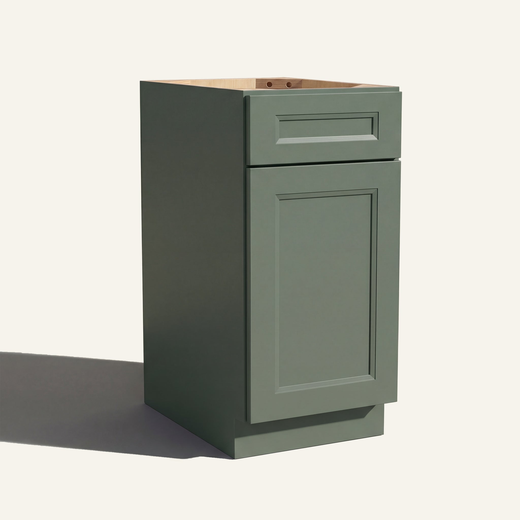Angled view of a green Belmont beveled Shaker vanity base cabinet with 1 door and 1 drawer.