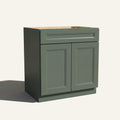 Angled view of a green Belmont beveled shaker double door vanity base with 2 doors and 1 drawer.