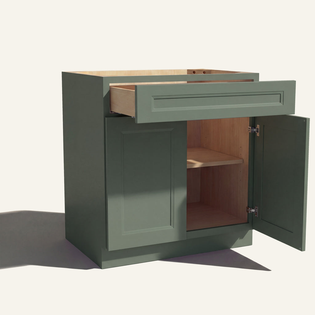 Angle view of a green Belmont beveled shaker base cabinet with 2 doors and 1 open drawer. Right door is open, showing a shelf.