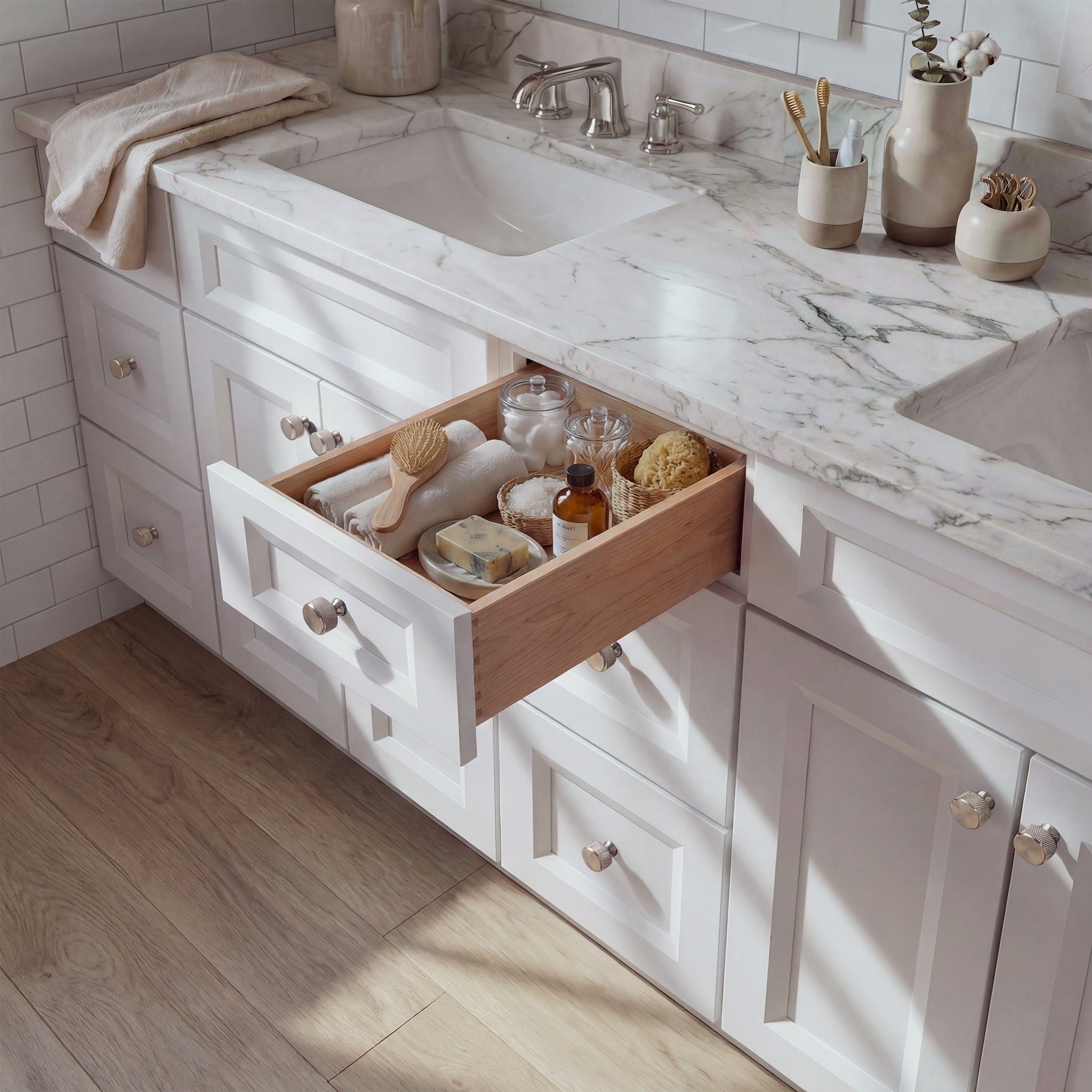 Top-down angled view of a white Belmont shaker vanity with an open drawer, lived-in feel, and Mont Blanc quartzite counter.