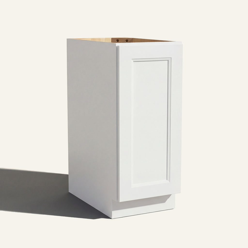 Angled view of a white Belmont beveled Shaker base cabinet with 1 full-height door.