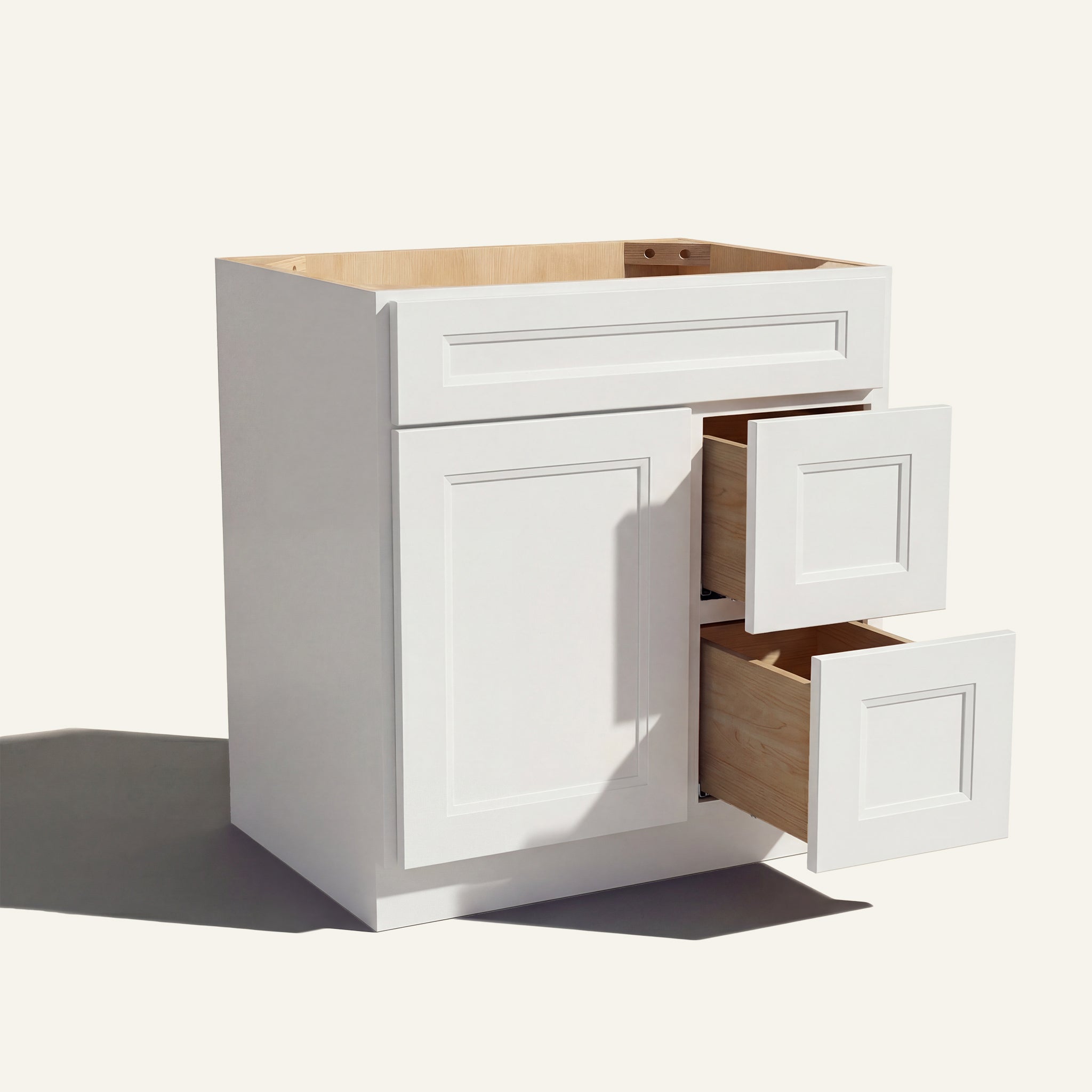 Warm bathroom scene of a white Belmont shaker single sink vanity with 1 door, 2 drawers right, and 1 false front.