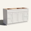 Angled view of a white Belmont beveled Shaker wide single sink vanity base with 2 doors, 4 drawers, and 1 false drawer front.