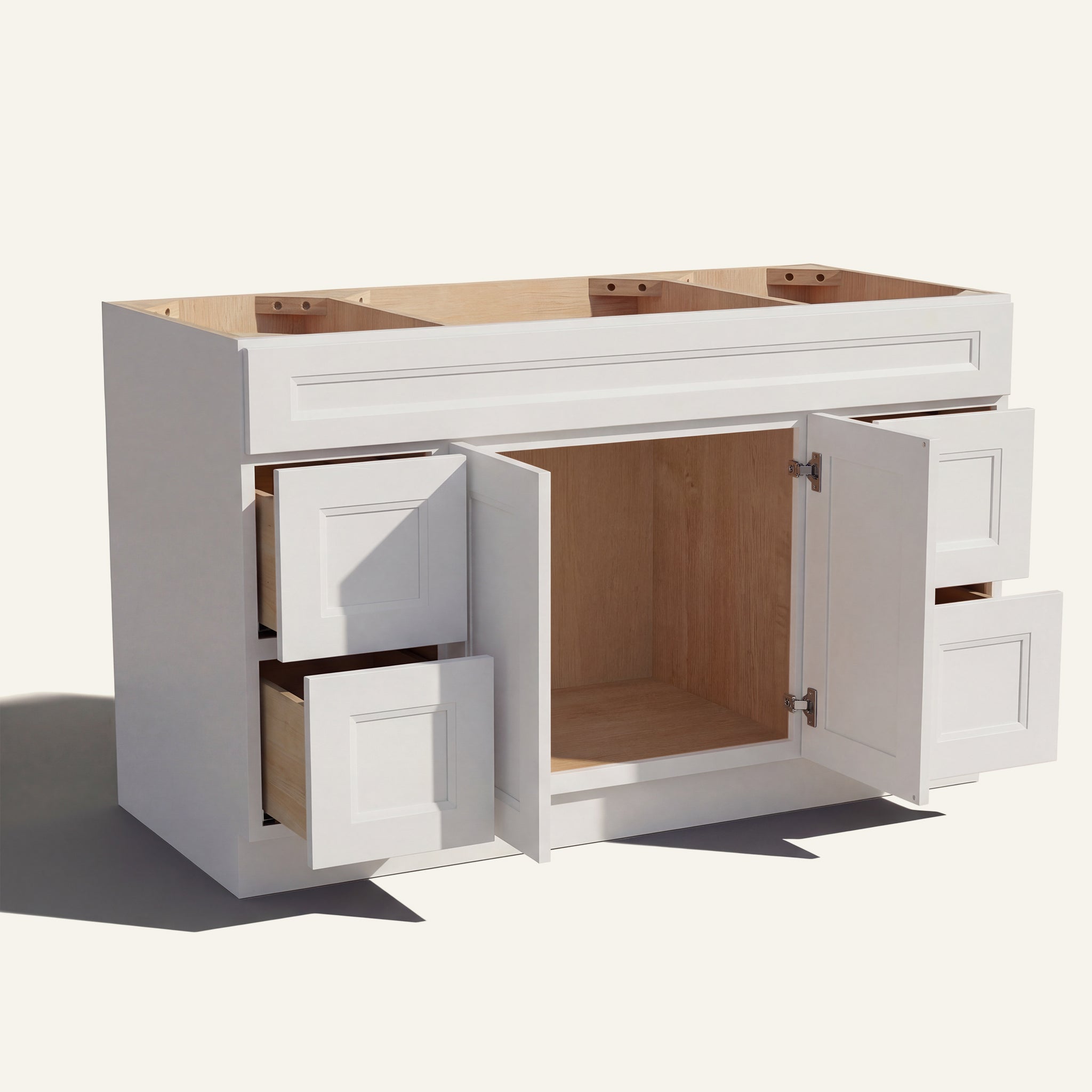 Open view of a white Belmont beveled Shaker single sink vanity base with 2 doors and 4 drawers showing the stained interior.