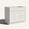 Angled view of white Belmont beveled Shaker single sink vanity, 2 doors, 2 drawers right, and 1 false drawer front.