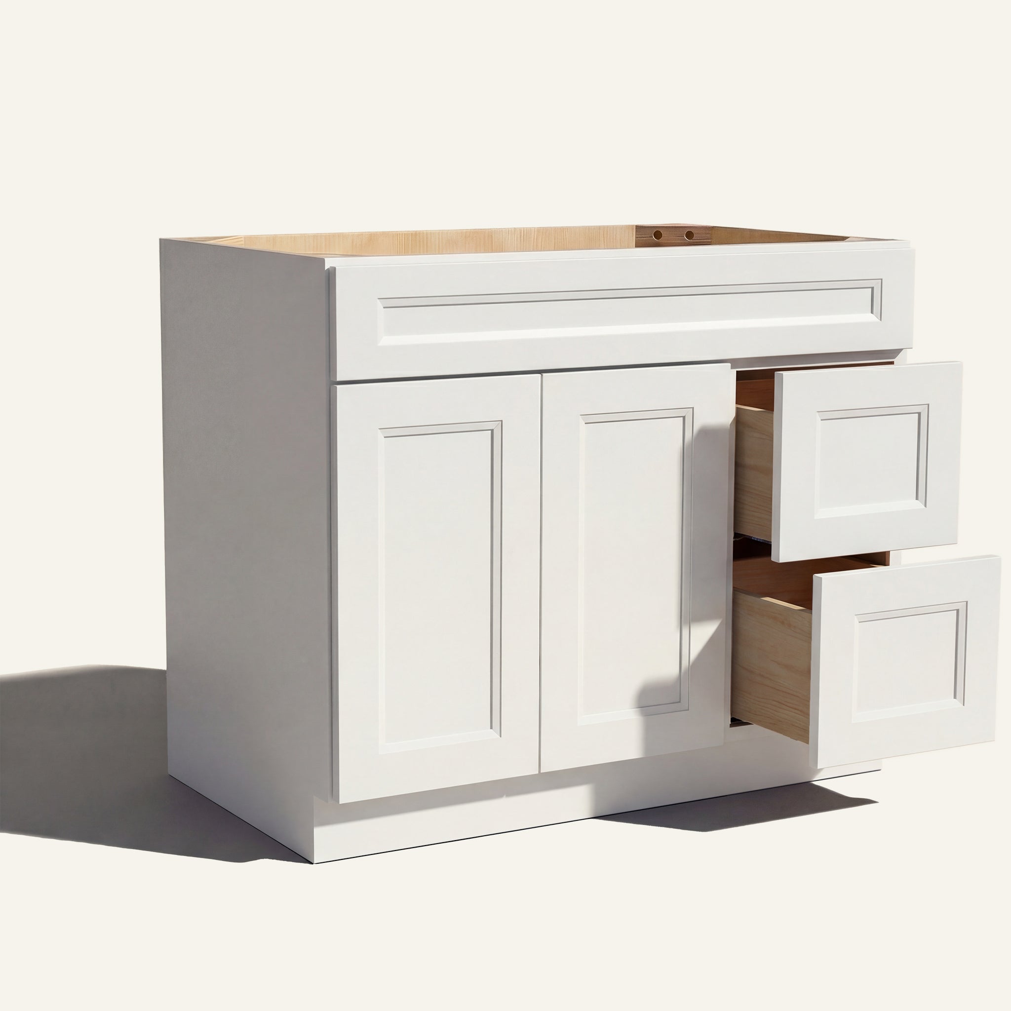 Open view of white Belmont beveled Shaker single sink vanity, 2 doors, 2 drawers right, and 1 false drawer front.