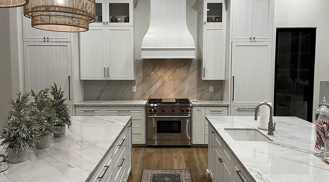 Kitchen with a bell style wood range hood