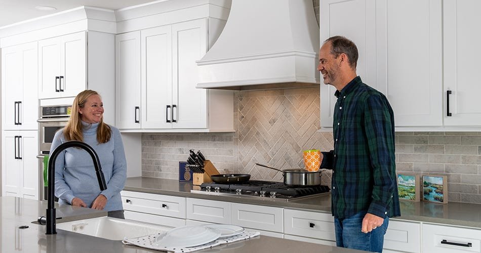 Kitchen with a curved style wood range hood