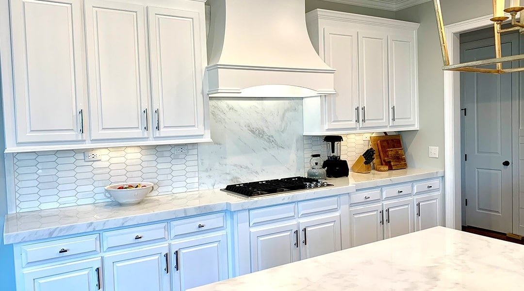 Kitchen with a curved style wood range hood