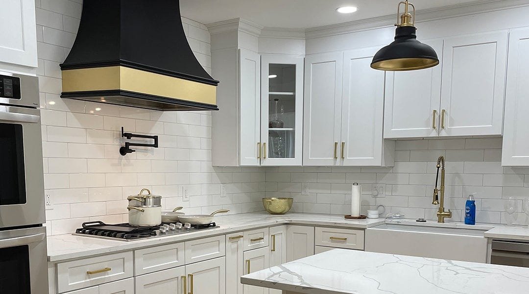 Kitchen with a curved style wood range hood