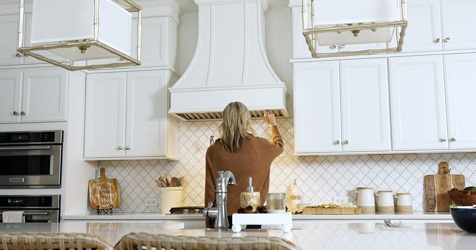 Kitchen with a curved style wood range hood
