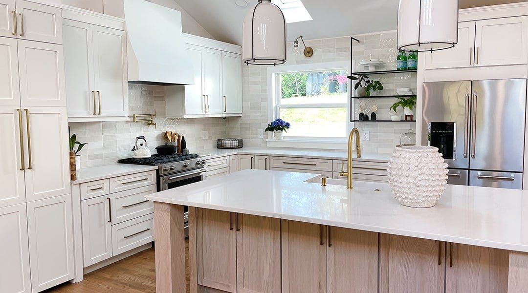 Kitchen with a sloped style wood range hood