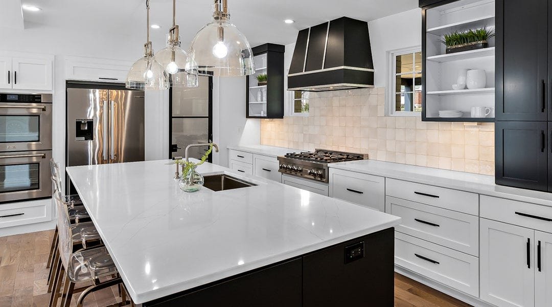 Kitchen with a tapered style wood range hood