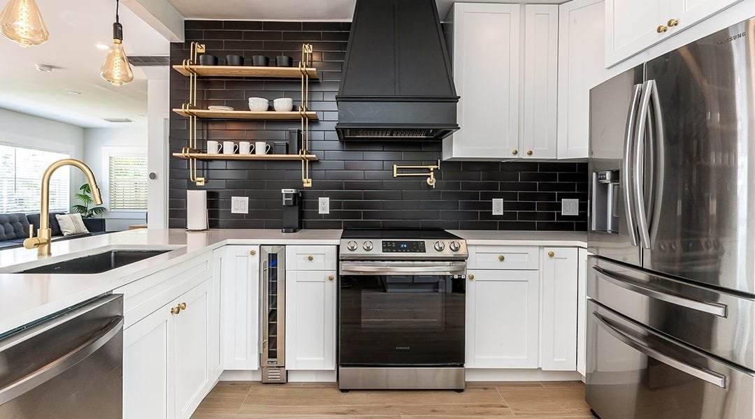 Kitchen with a tapered style wood range hood