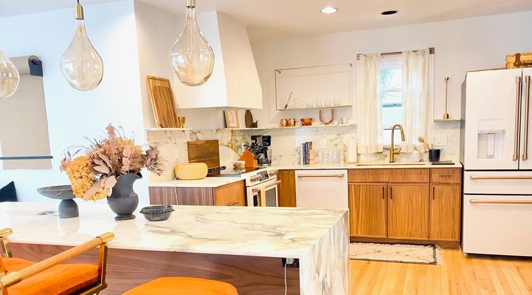 Kitchen with a tapered style wood range hood
