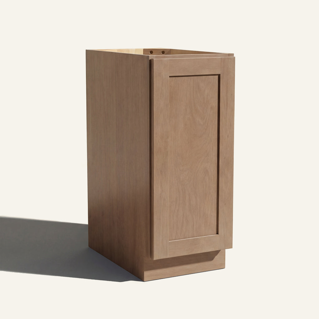Angled view of a driftwood Seaport Shaker base cabinet with 1 full-height door.