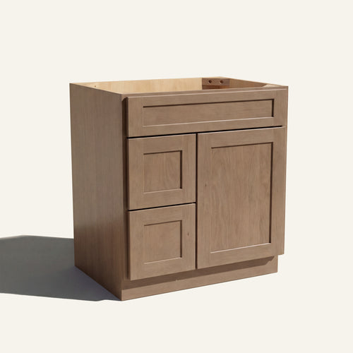 Angled view of a driftwood Seaport shaker single sink vanity with a right-side door and two left-side drawers.
