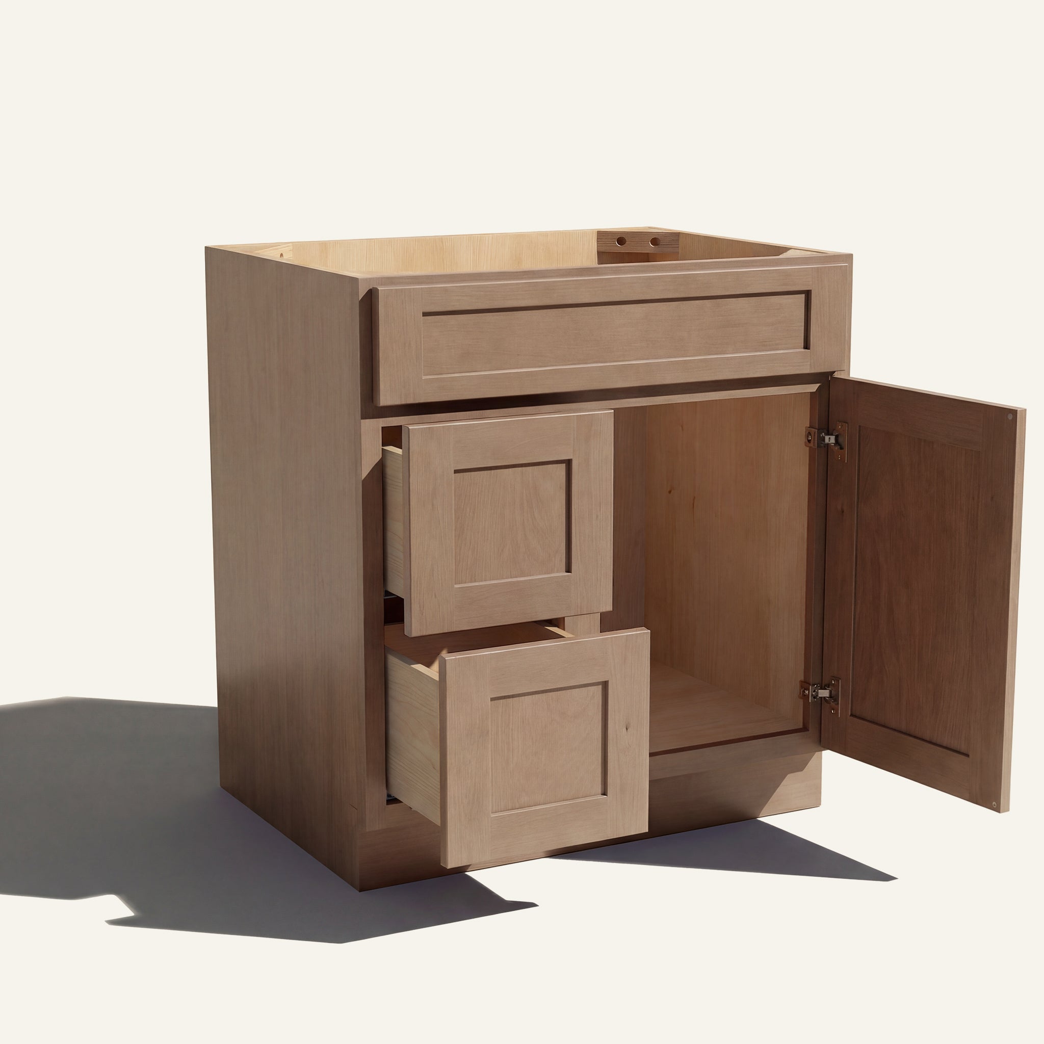 Open view of a driftwood Seaport shaker single sink vanity with 1 door and 2 drawers on the left.