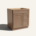 Angled view of a driftwood Seaport shaker single sink vanity with a left-side door and two right-side drawers.