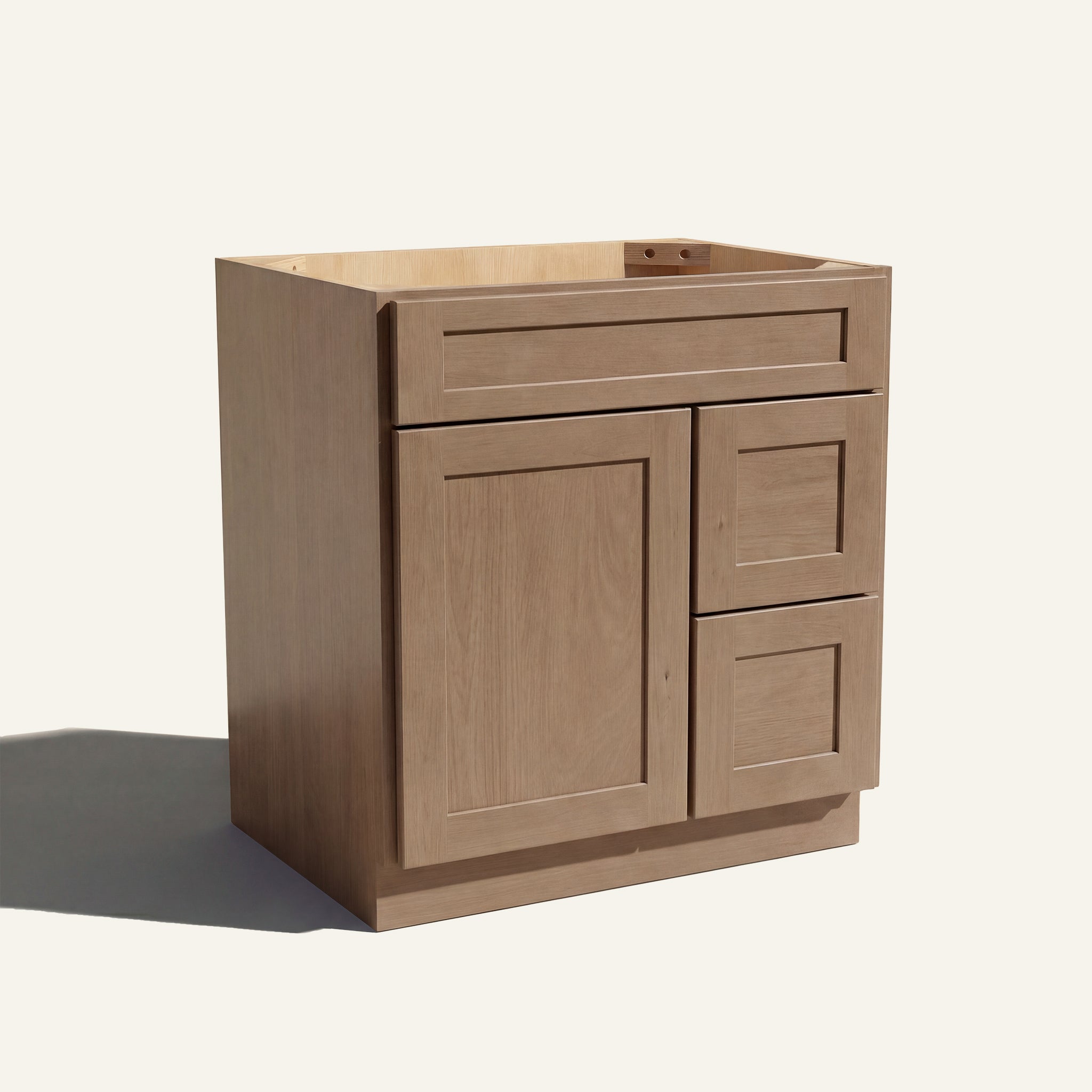 Angled view of a driftwood Seaport shaker single sink vanity with a left-side door and two right-side drawers.