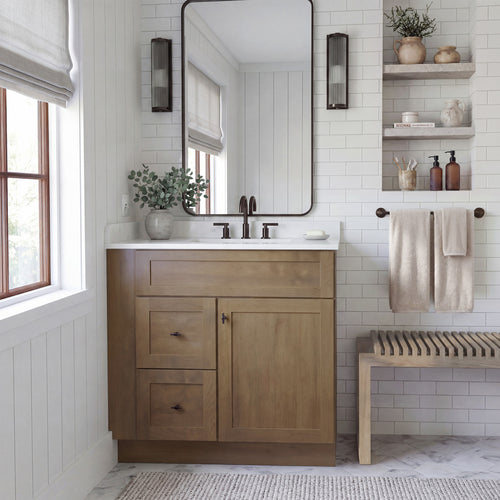 Front view of a driftwood Seaport shaker single sink vanity with 1 door, 2 drawers left, and 1 false drawer in a warm bathroom.
