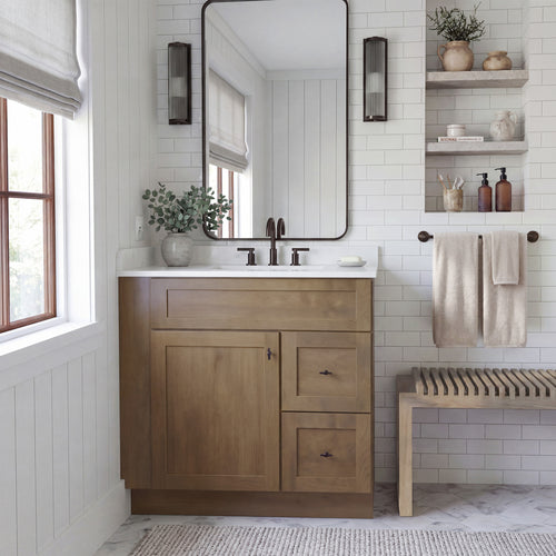 Warm bathroom scene of a driftwood Seaport shaker single sink vanity with 1 door, 2 drawers right, and 1 false front.
