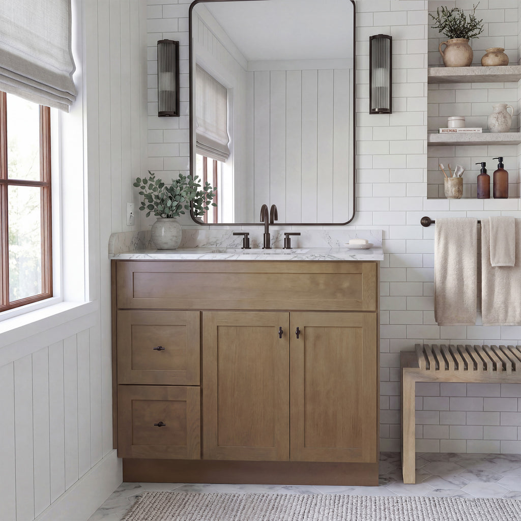 Front view of a driftwood Seaport shaker vanity with 2 doors, 2 drawers left, and 1 false drawer in a warm traditional bathroom.