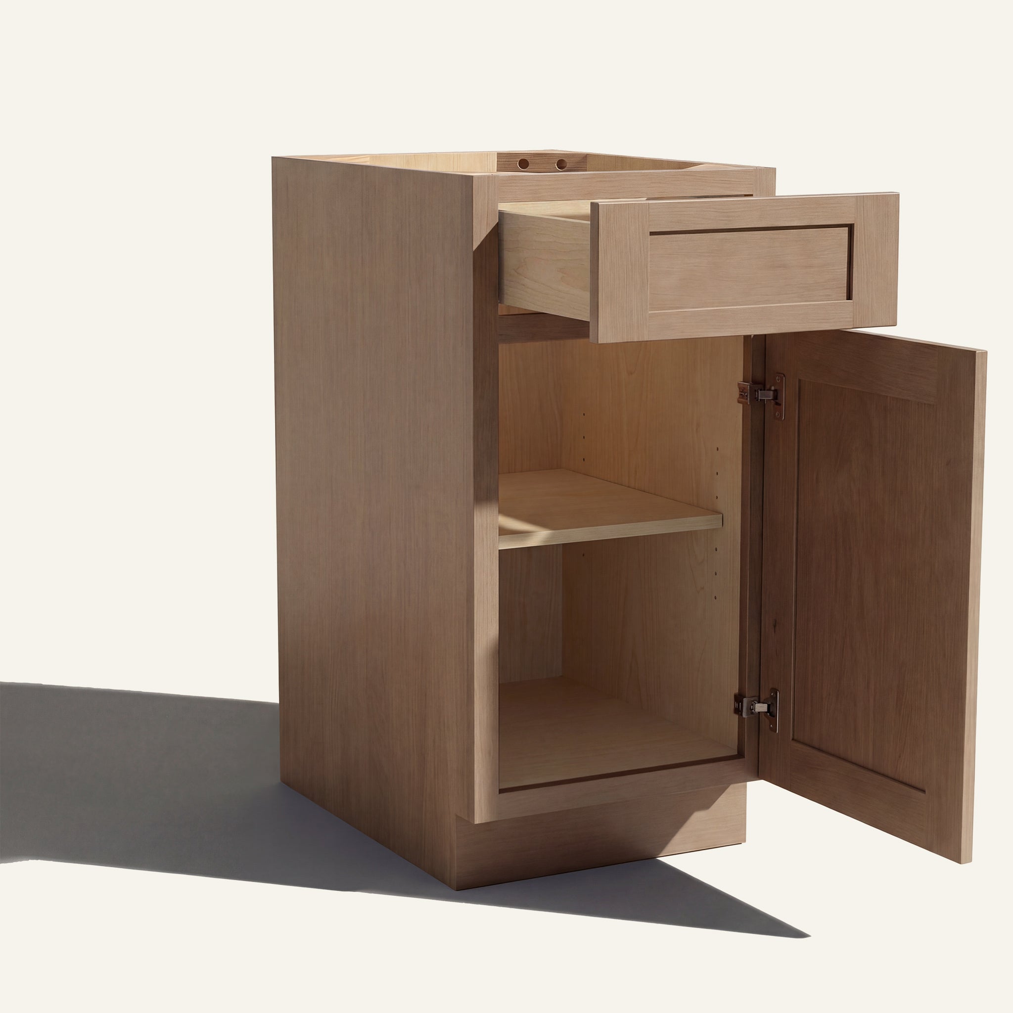 Angled view of a driftwood Seaport Shaker vanity base cabinet with 1 door and 1 drawer open showing wood interior.