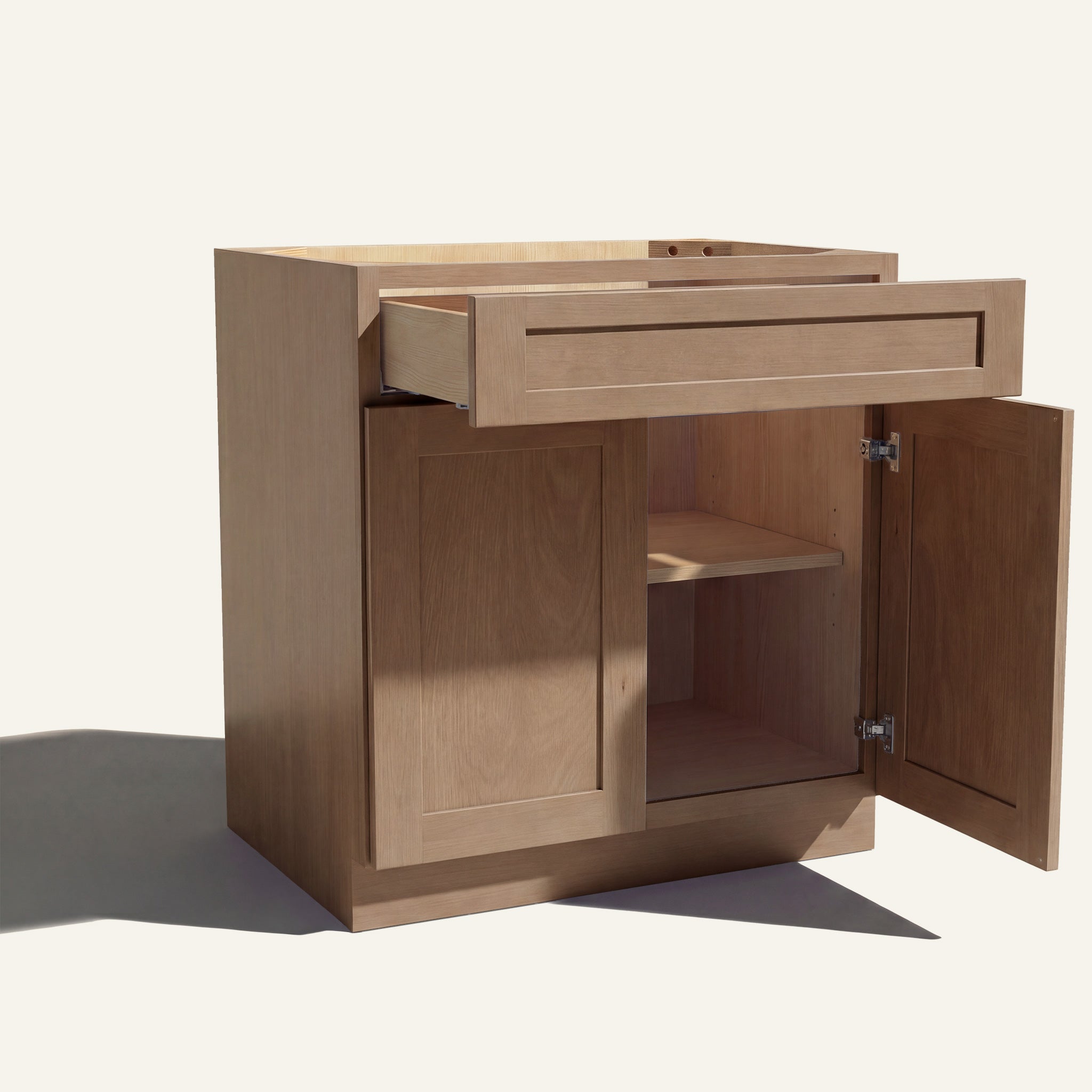 Angle view of a driftwood Seaport shaker base cabinet with 2 doors and 1 open drawer. Right door is open, showing a shelf.
