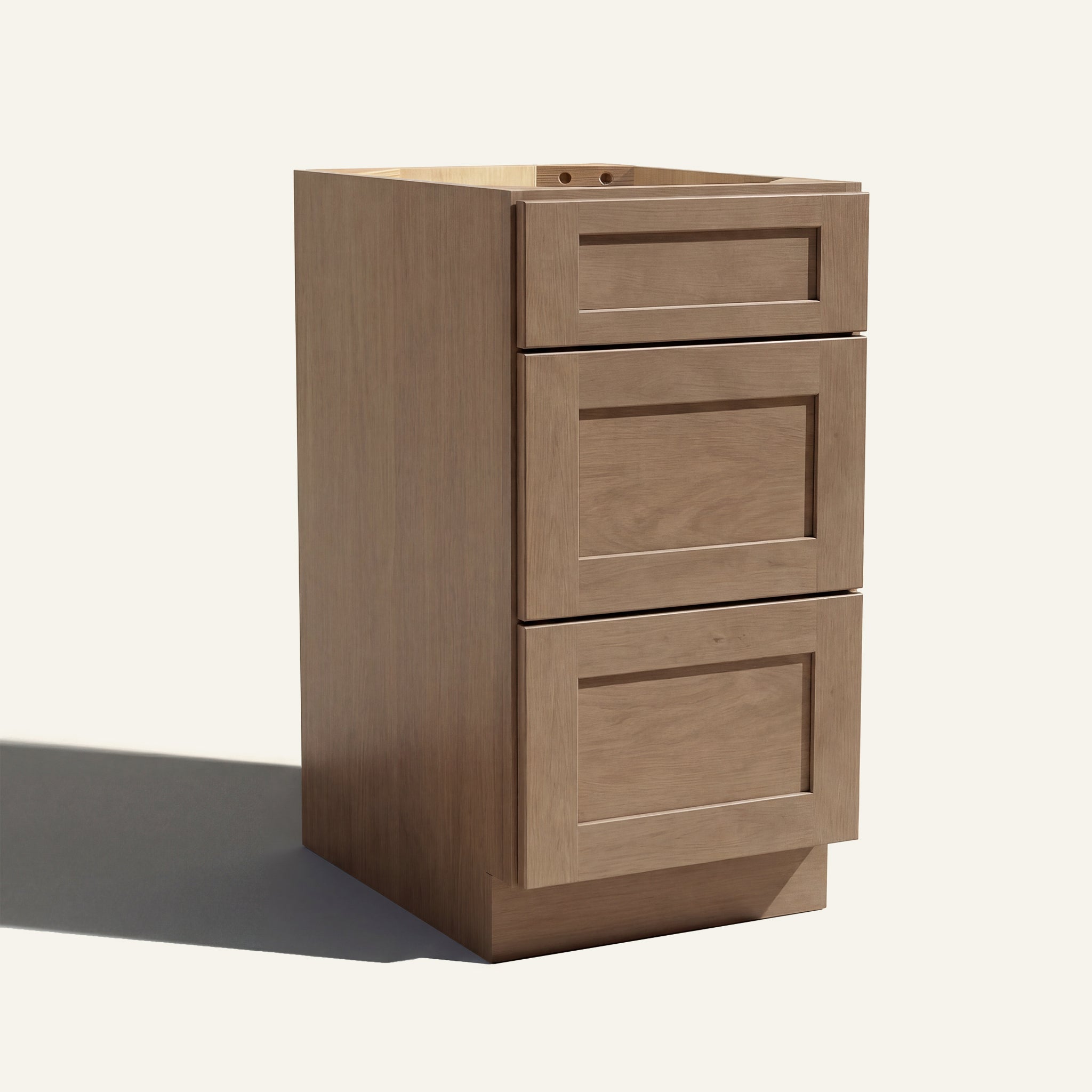 Angled view of a driftwood Seaport Shaker vanity base with 3 drawers stacked.