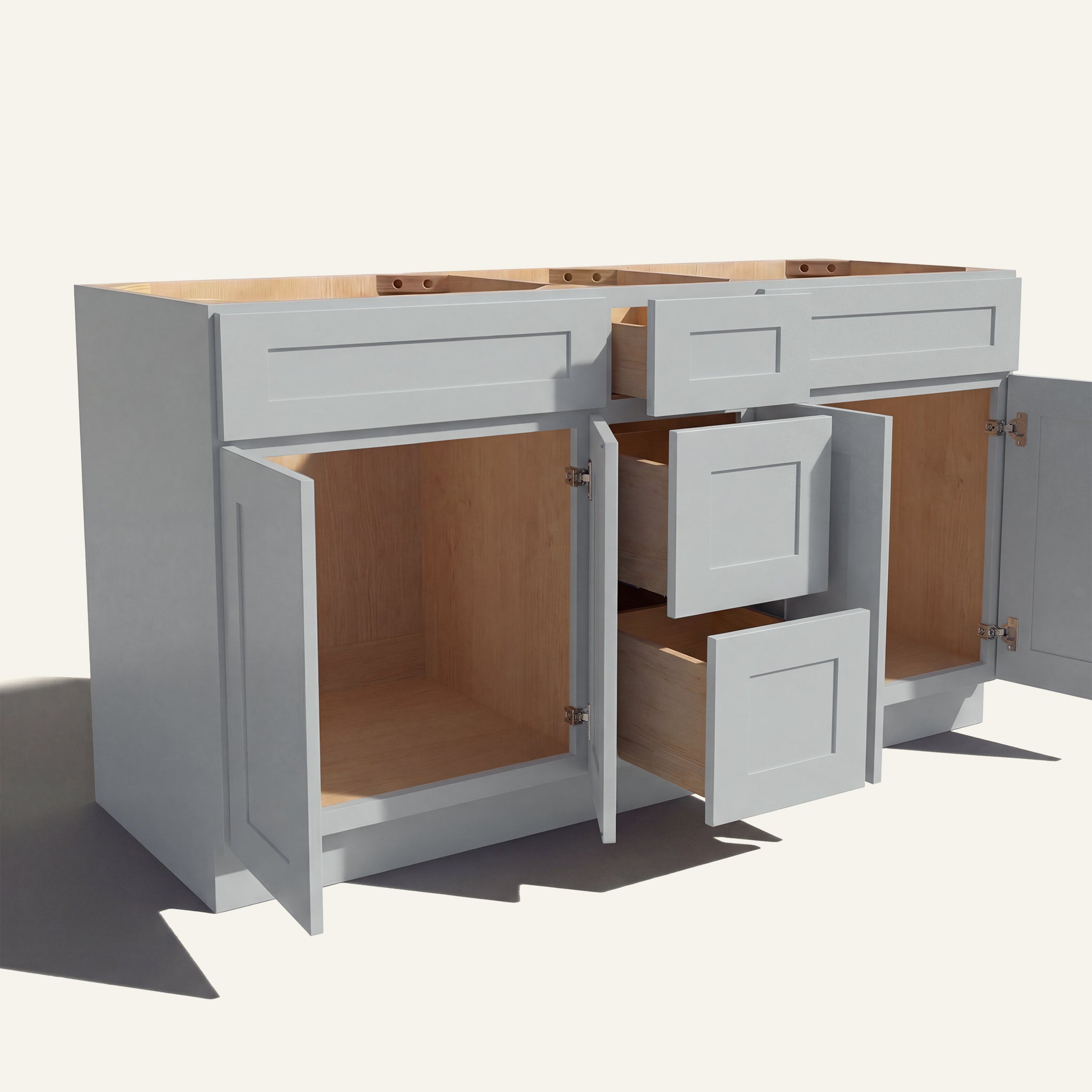 Angled view of a light gray Seaport Shaker double sink vanity base with doors and 3 drawers open showing wood interior.