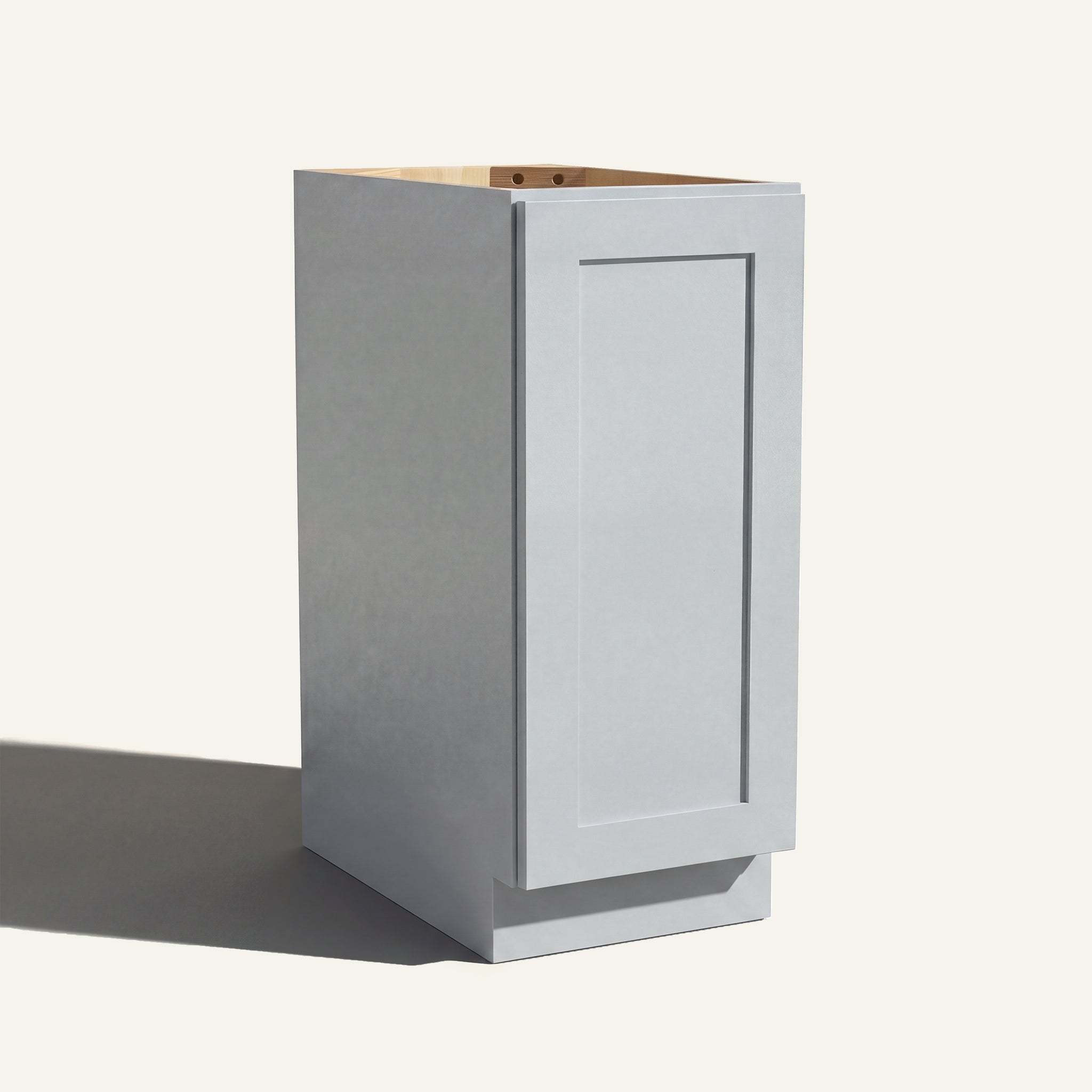Angled view of a light gray Seaport Shaker base cabinet with 1 full-height door.