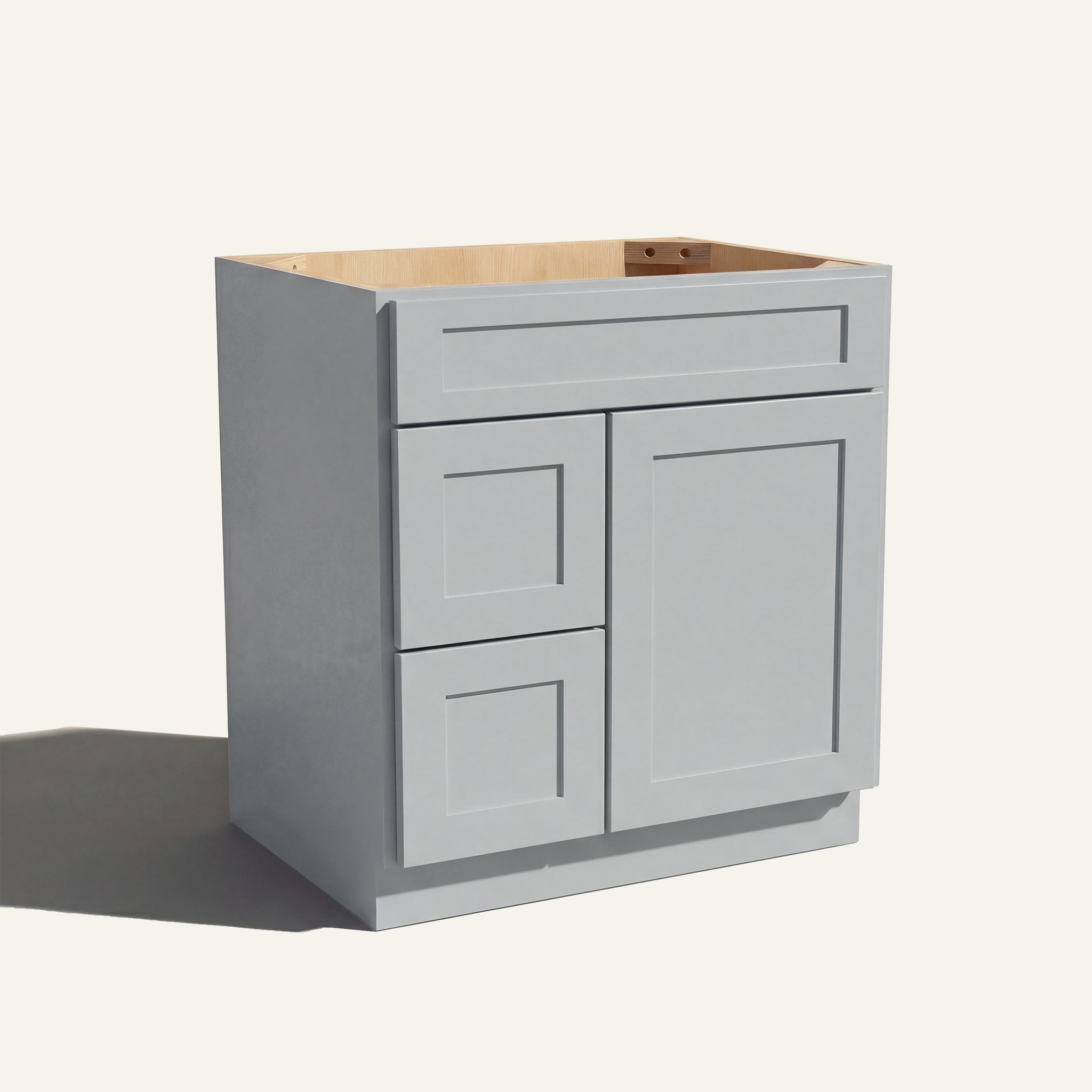 Angled view of a light gray Seaport shaker single sink vanity with a right-side door and two left-side drawers.