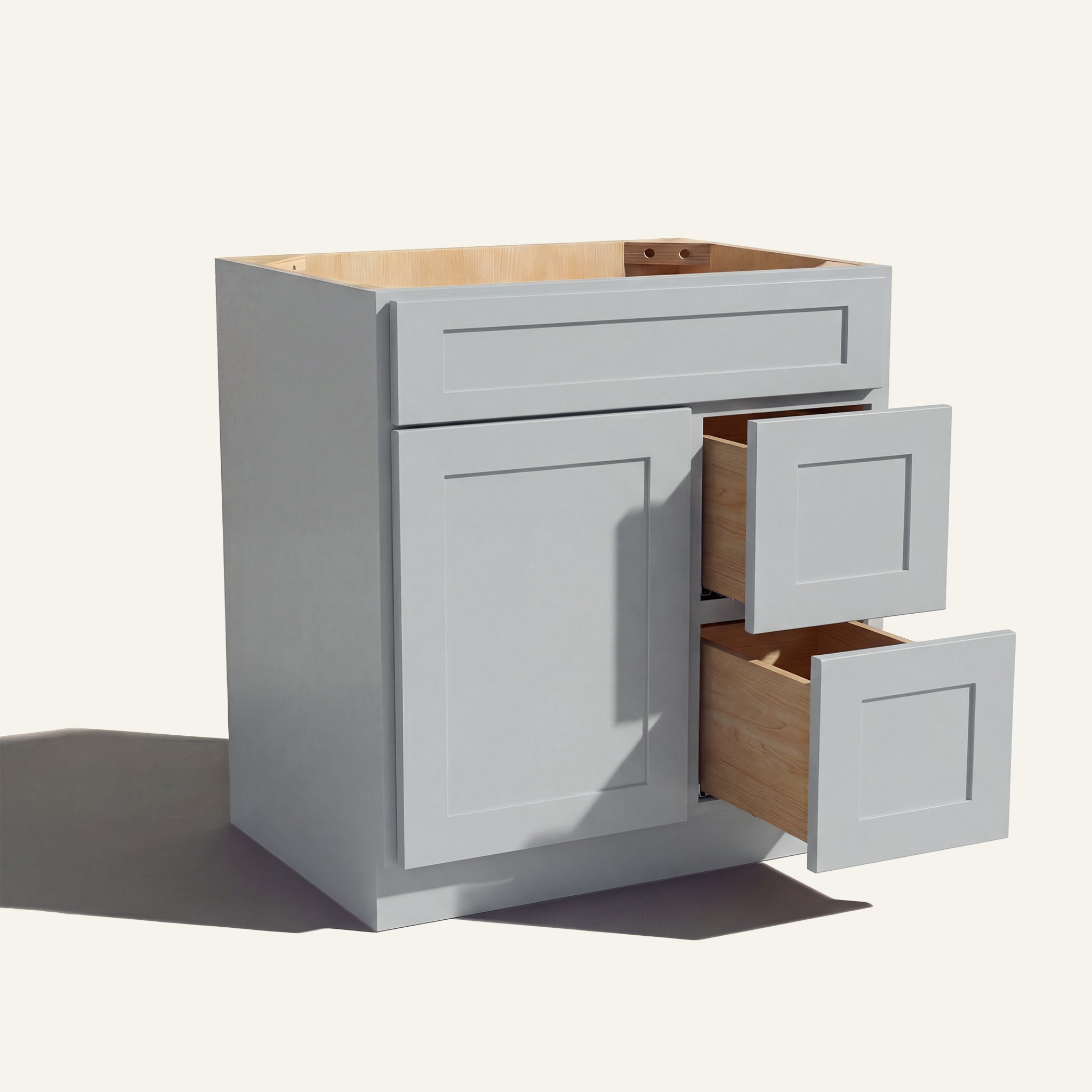 Warm bathroom scene of a light gray Seaport shaker single sink vanity with 1 door, 2 drawers right, and 1 false front.