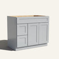 Angled view of a light gray Seaport shaker single sink vanity featuring two doors and a left-side drawer bank.