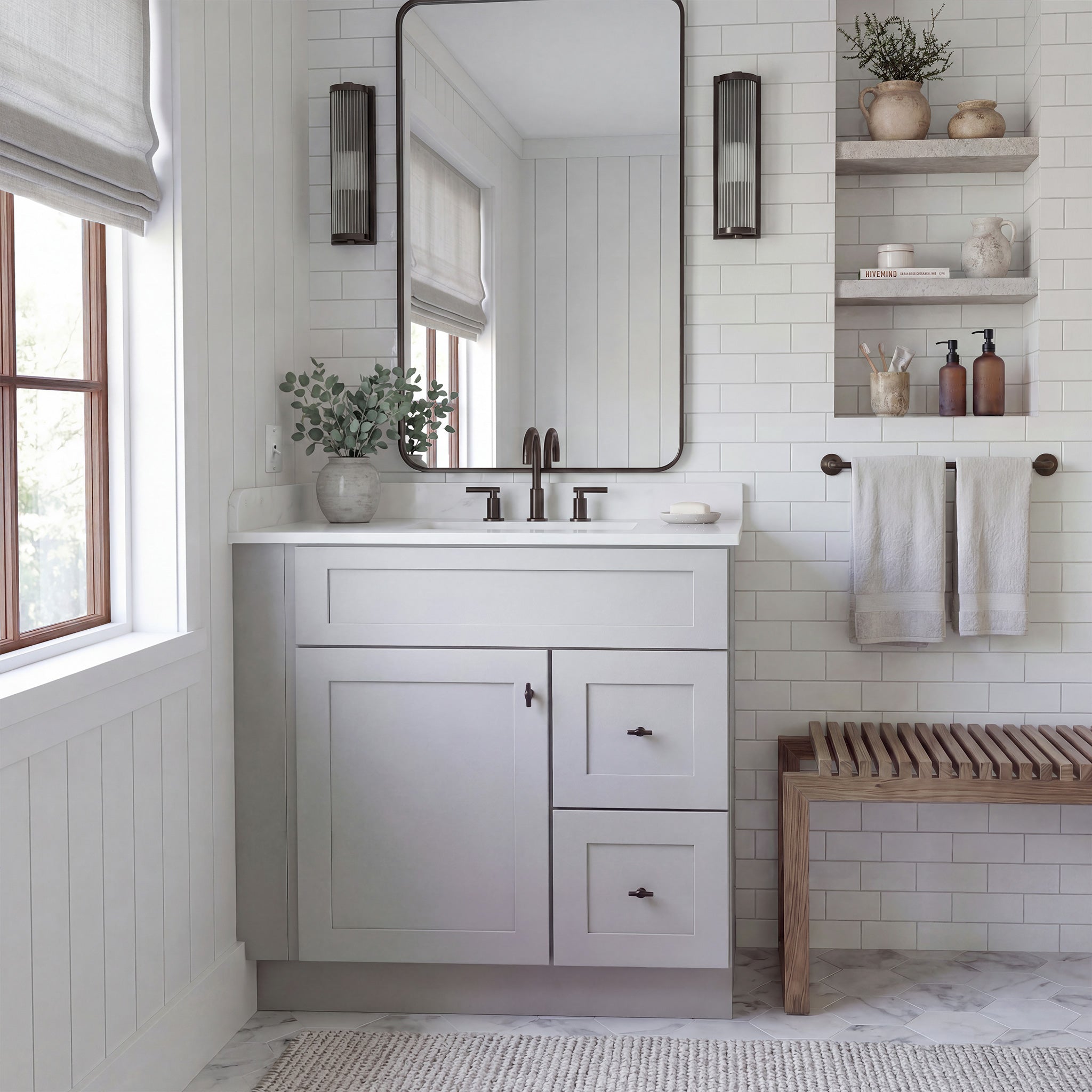 Warm bathroom scene of a light gray Seaport shaker single sink vanity with 1 door, 2 drawers right, and 1 false front.