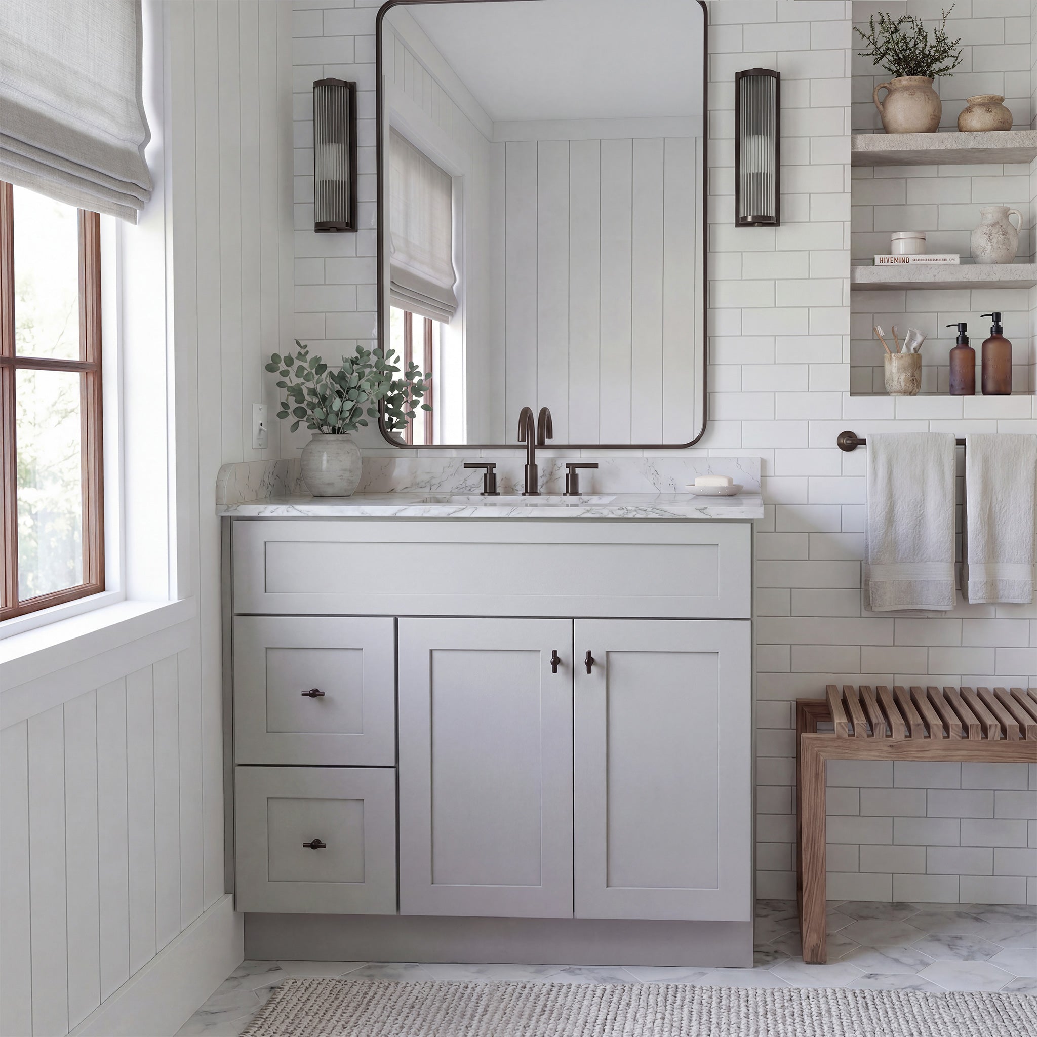 Front view of a light gray Seaport shaker vanity with 2 doors, 2 drawers left, and 1 false drawer in a warm traditional bathroom.