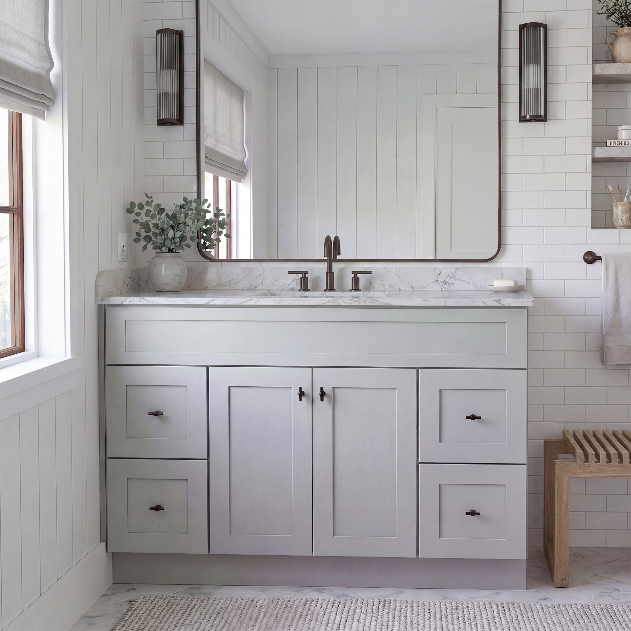Front view of a light gray Seaport shaker vanity with 2 doors, 4 drawers, and 1 false drawer front in a warm traditional bathroom.