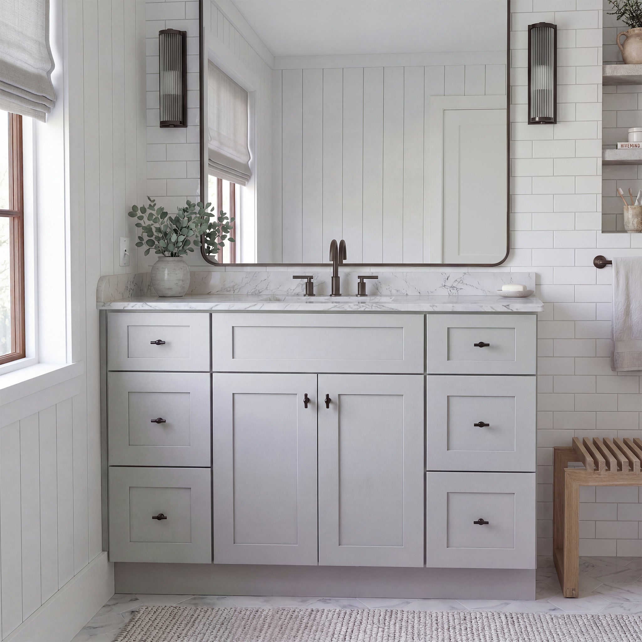 Front view of a light gray Seaport shaker vanity with 2 doors, 6 drawers, and 1 false drawer front in a warm traditional bathroom.