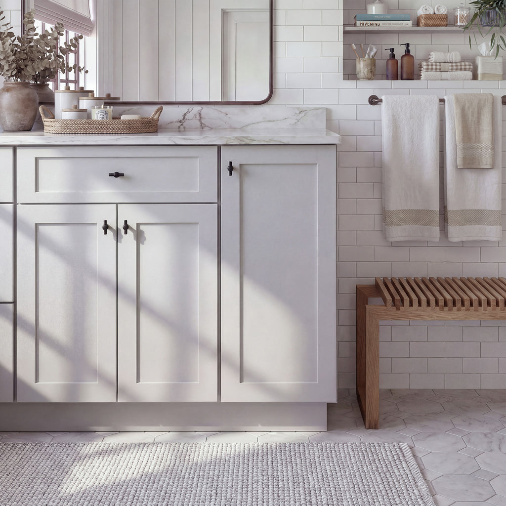Front view of a light gray Seaport traditional vanity base cabinet with 3 doors and 1 drawer in a styled bathroom.