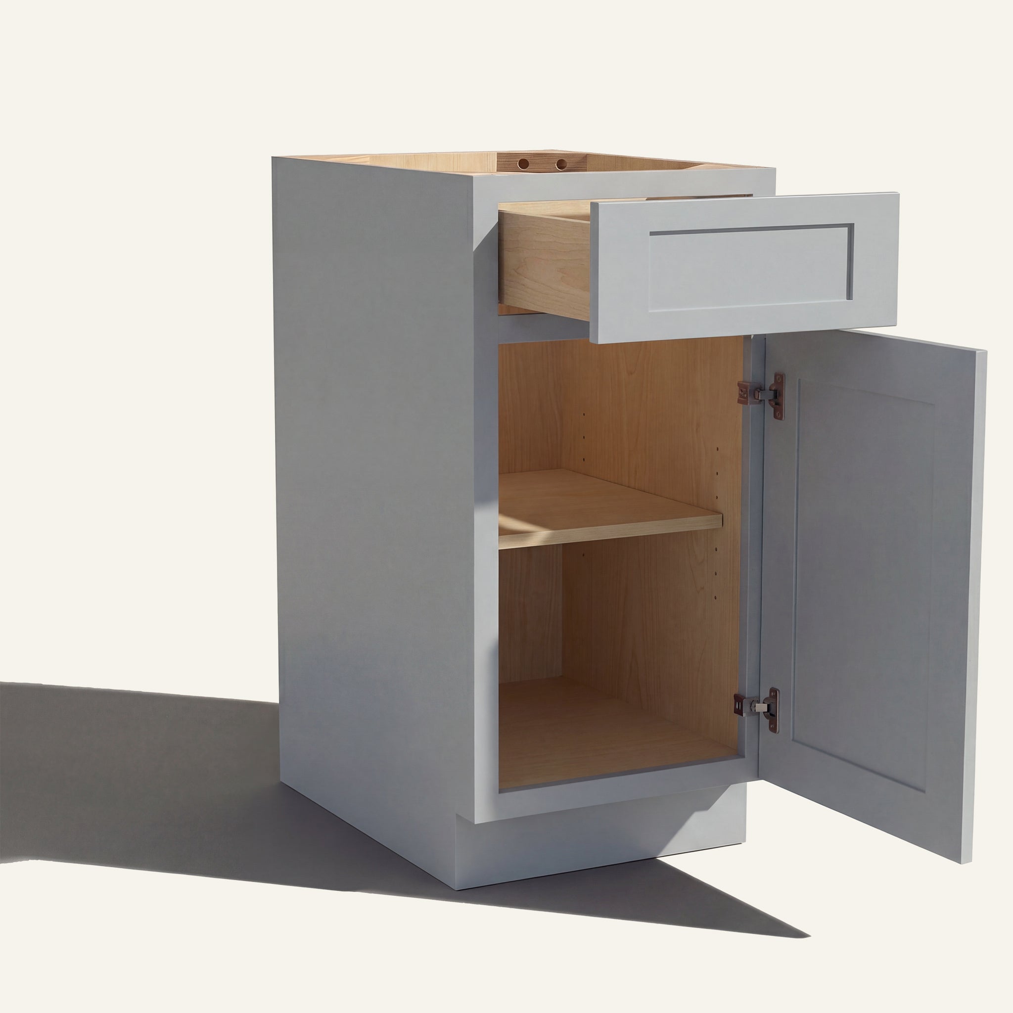 Angled view of a light gray Seaport Shaker vanity base cabinet with 1 door and 1 drawer open showing wood interior.