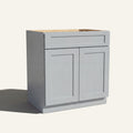 Angled view of a light gray Seaport shaker double door vanity base with 2 doors and 1 drawer.