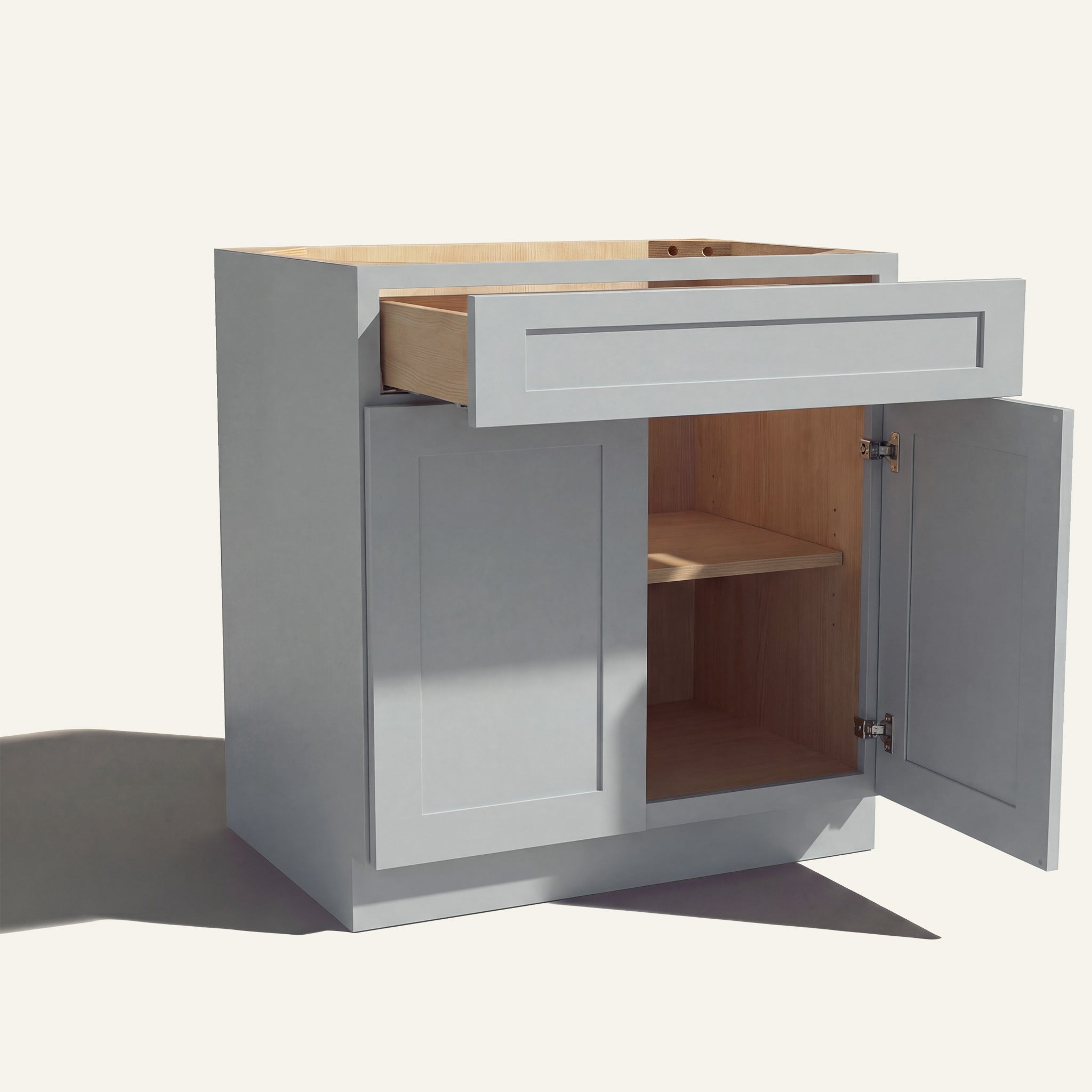 Angle view of a light gray Seaport shaker base cabinet with 2 doors and 1 open drawer. Right door is open, showing a shelf.