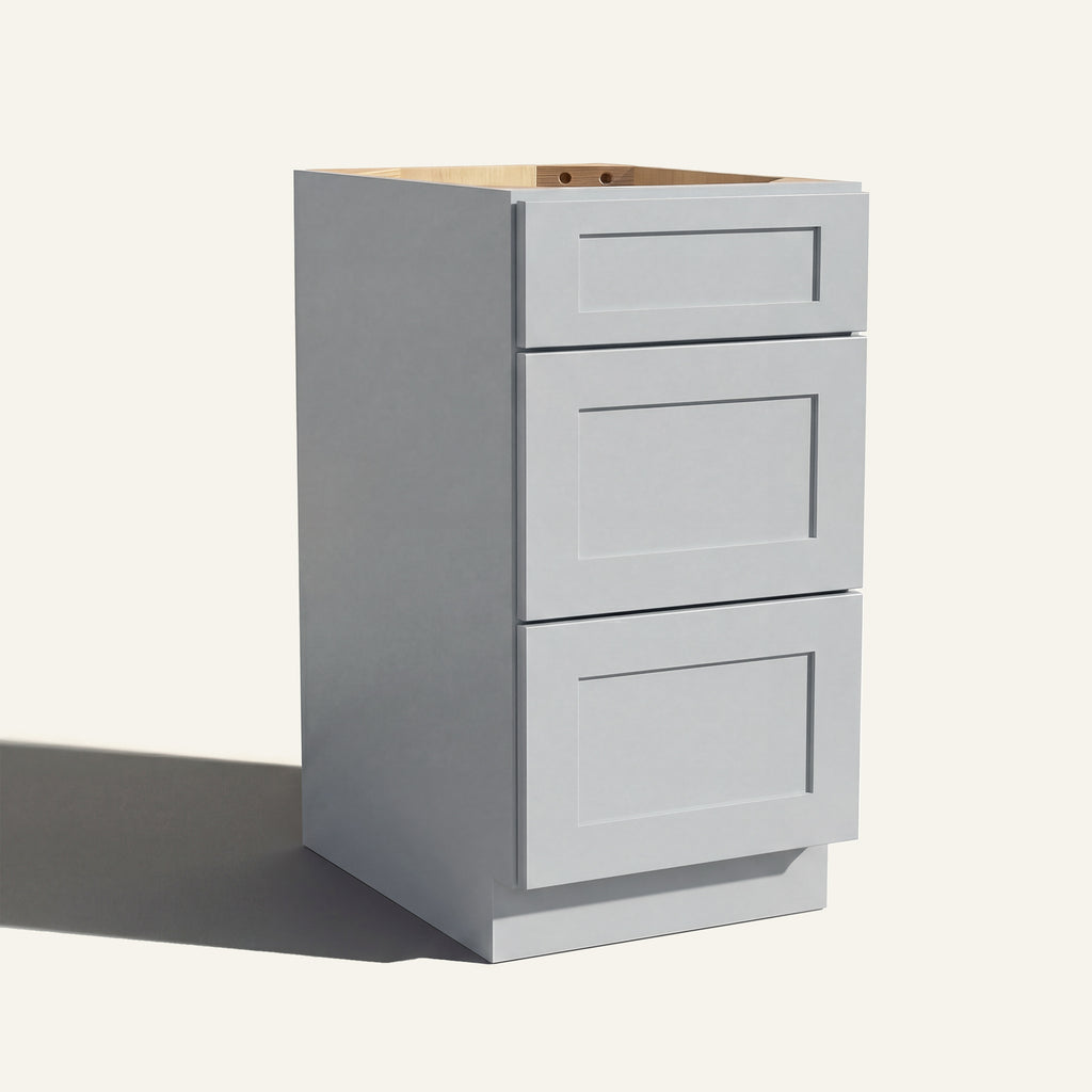 Angled view of a light gray Seaport Shaker vanity base with 3 drawers stacked.