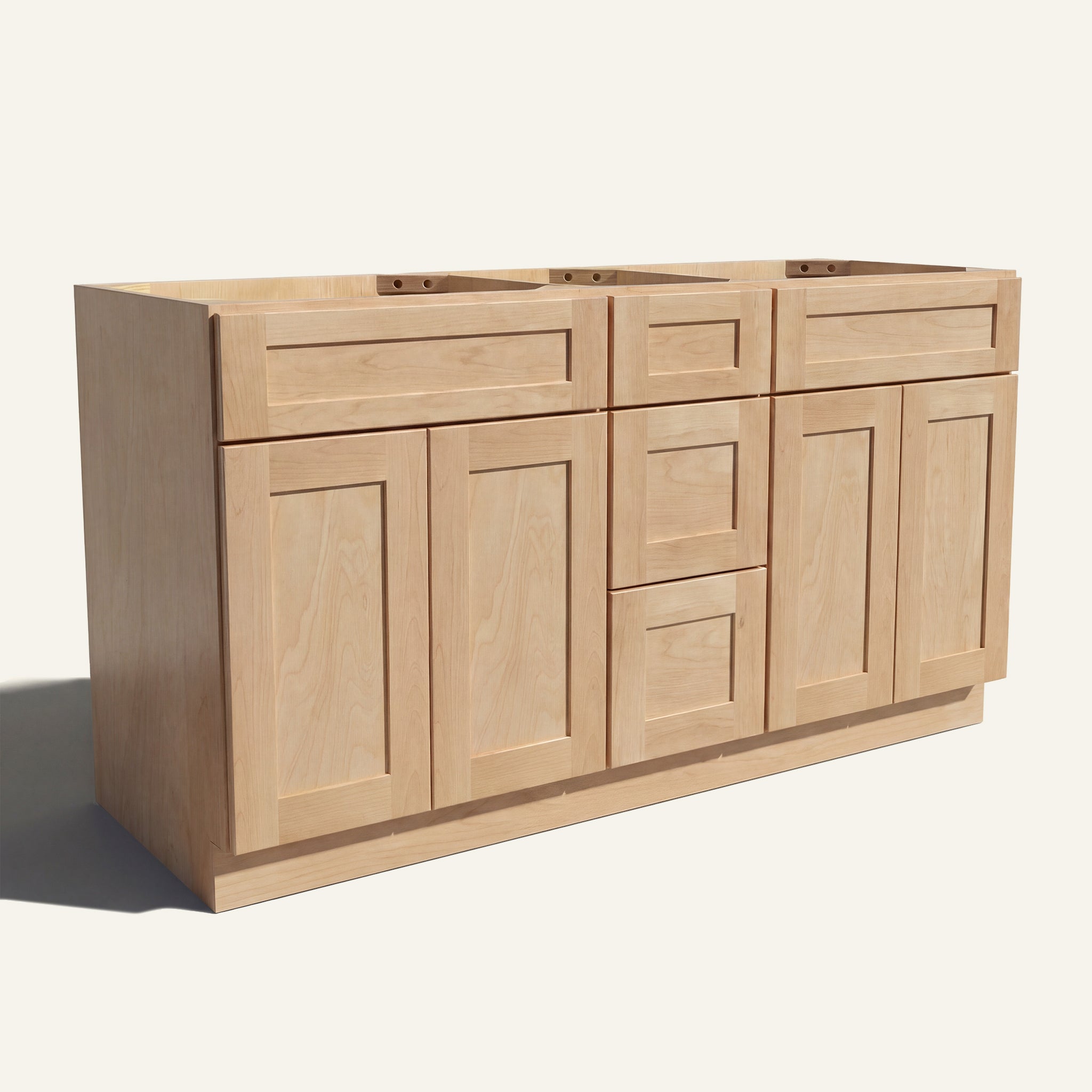 Angled view of a natural Seaport Shaker double sink vanity base with 4 doors, 3 drawers, and 2 false drawer fronts.