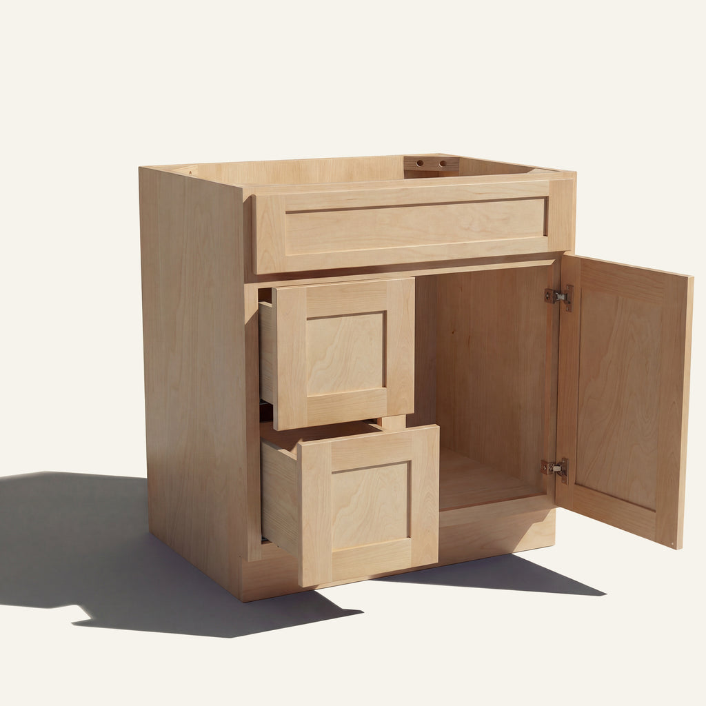 Open view of a natural Seaport shaker single sink vanity with 1 door and 2 drawers on the left.