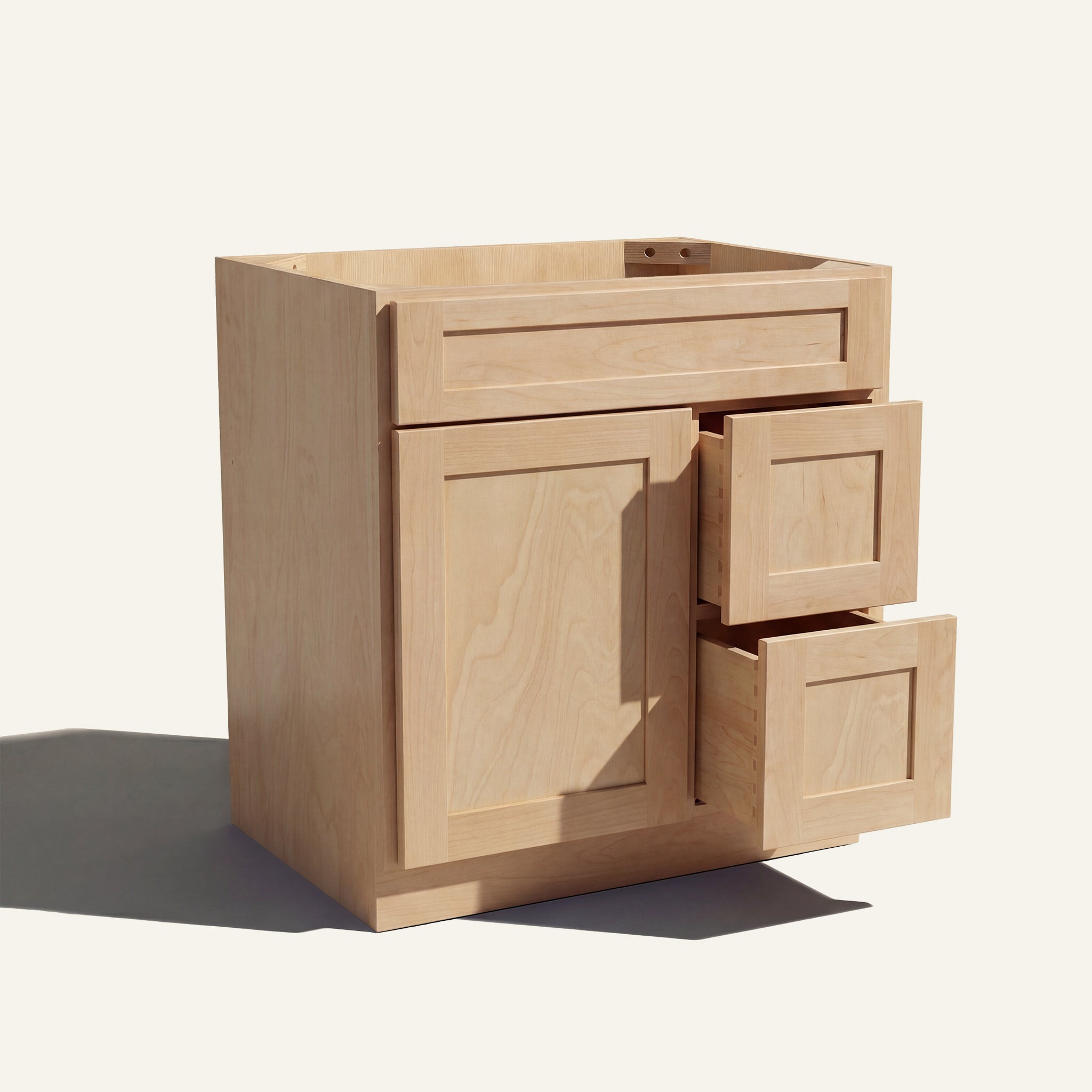 Warm bathroom scene of a natural Seaport shaker single sink vanity with 1 door, 2 drawers right, and 1 false front.