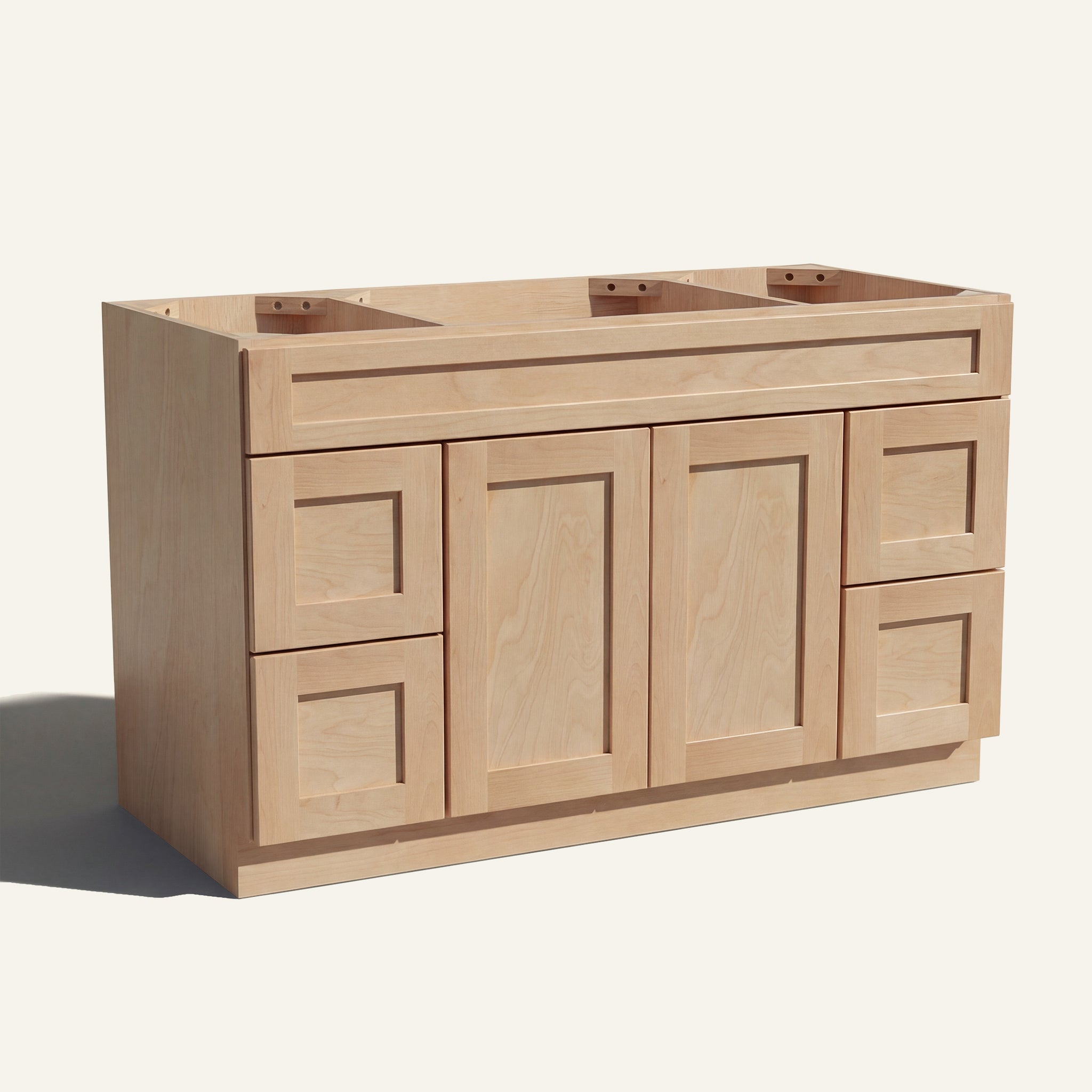 Angled view of a natural Seaport Shaker wide single sink vanity base with 2 doors, 4 drawers, and 1 false drawer front.
