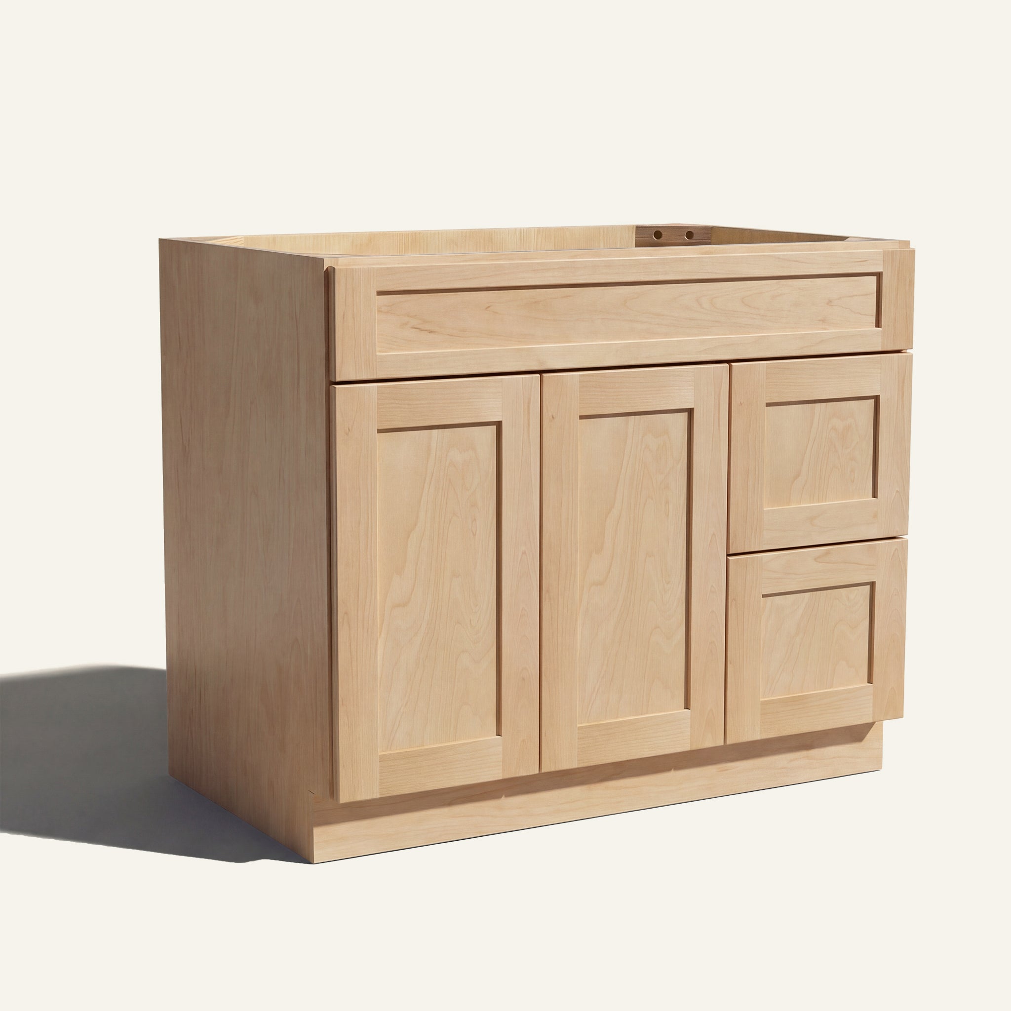 Angled view of natural Seaport Shaker single sink vanity, 2 doors, 2 drawers right, and 1 false drawer front.